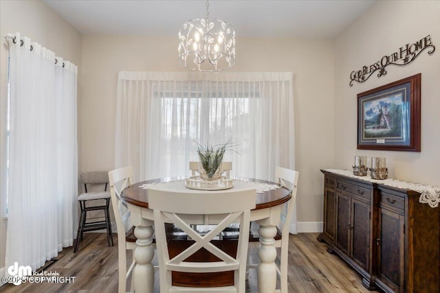 1630 S Corwin Ln, Wasilla, AK 99654 - dining space with light wood-type flooring, a chandelier, and baseboards