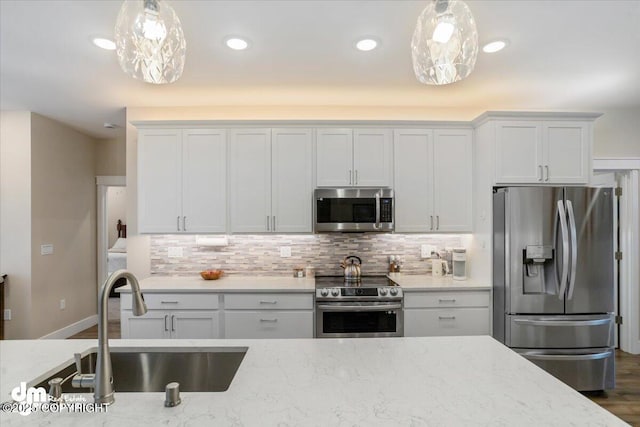 1630 S Corwin Ln, Wasilla, AK 99654 - kitchen featuring appliances with stainless steel finishes, a sink, tasteful backsplash, pendant lighting, and recessed lighting