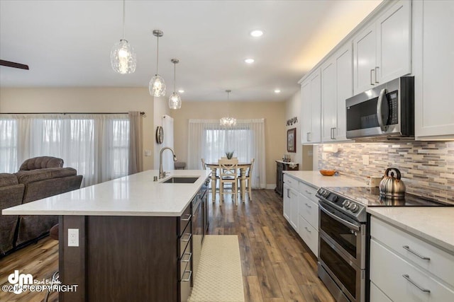 1630 S Corwin Ln, Wasilla, AK 99654 - kitchen featuring appliances with stainless steel finishes, a sink, open floor plan, backsplash, and dark wood-type flooring