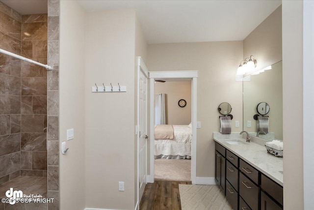 1630 S Corwin Ln, Wasilla, AK 99654 - full bath with double vanity, wood finished floors, tiled shower, ensuite bathroom, and baseboards