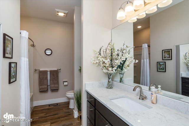1630 S Corwin Ln, Wasilla, AK 99654 - full bath featuring vanity, wood finished floors, toilet, baseboards, and shower / tub combo