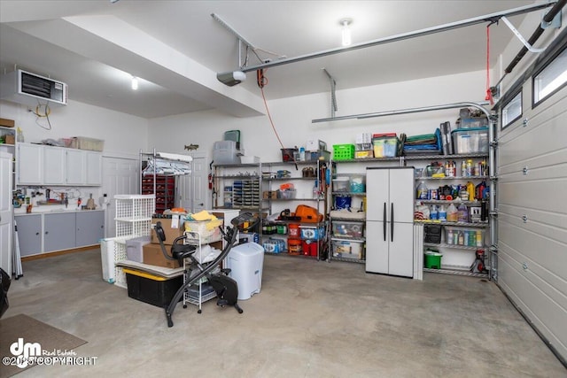 1630 S Corwin Ln, Wasilla, AK 99654 - garage featuring a garage door opener, a heating unit, and freestanding refrigerator