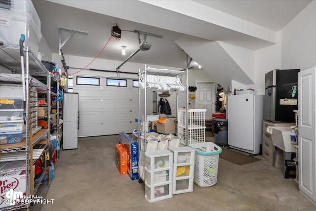 1630 S Corwin Ln, Wasilla, AK 99654 - garage featuring freestanding refrigerator and a garage door opener