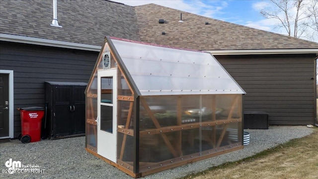 1630 S Corwin Ln, Wasilla, AK 99654 - exterior view of a shingled roof, an exterior structure, gutters, and a downspout