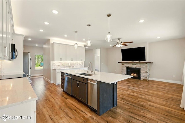 1630 S Corwin Ln, Wasilla, AK 99654 - kitchen featuring a ceiling fan, stainless steel appliances, white cabinetry, light wood finished floors, and recessed lighting