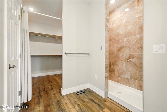 1630 S Corwin Ln, Wasilla, AK 99654 - full bath with tiled shower, hardwood / wood-style floors, a spacious closet, and recessed lighting