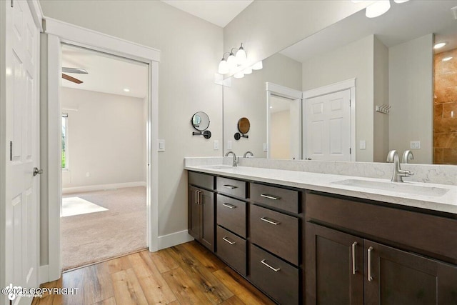 1630 S Corwin Ln, Wasilla, AK 99654 - bathroom with hardwood / wood-style flooring, double vanity, and ceiling fan