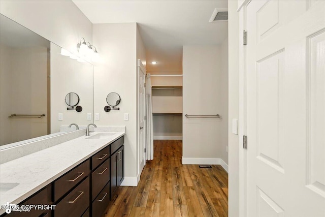 1630 S Corwin Ln, Wasilla, AK 99654 - full bath with double vanity, wood-type flooring, recessed lighting, and a spacious closet