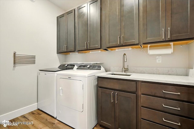 1630 S Corwin Ln, Wasilla, AK 99654 - laundry room with washer and clothes dryer, cabinet space, and light wood finished floors