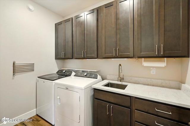 1630 S Corwin Ln, Wasilla, AK 99654 - washroom with independent washer and dryer, cabinet space, and wood finished floors