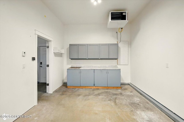 1630 S Corwin Ln, Wasilla, AK 99654 - kitchen with gray cabinets, concrete flooring, and a heating unit