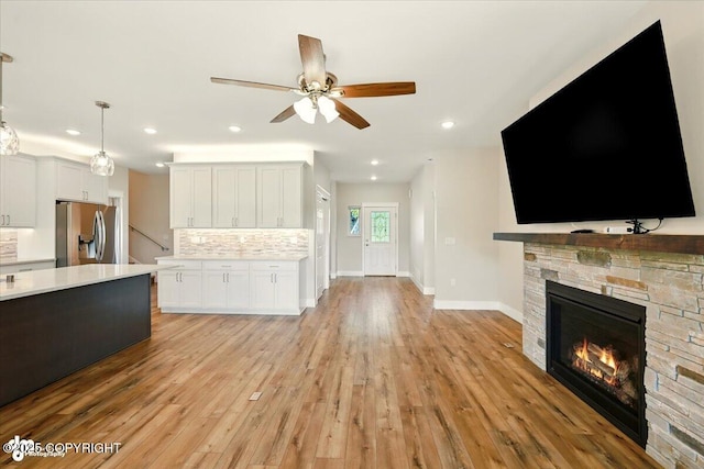 1630 S Corwin Ln, Wasilla, AK 99654 - kitchen with stainless steel fridge, light countertops, decorative backsplash, a ceiling fan, and light wood-style flooring