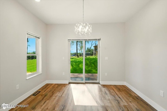 1630 S Corwin Ln, Wasilla, AK 99654 - unfurnished dining area featuring a chandelier and wood finished floors