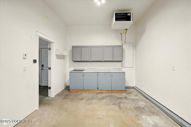 1630 S Corwin Ln, Wasilla, AK 99654 - kitchen featuring gray cabinetry, concrete floors, and a heating unit