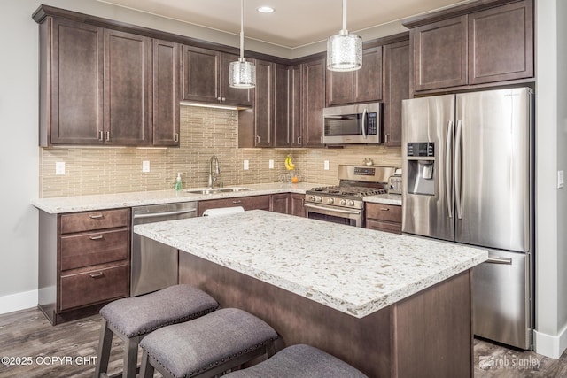 6552 N Michelle Rae St, Wasilla, AK 99654 - kitchen with stainless steel appliances, a sink, dark wood-style flooring, baseboards, and dark brown cabinetry