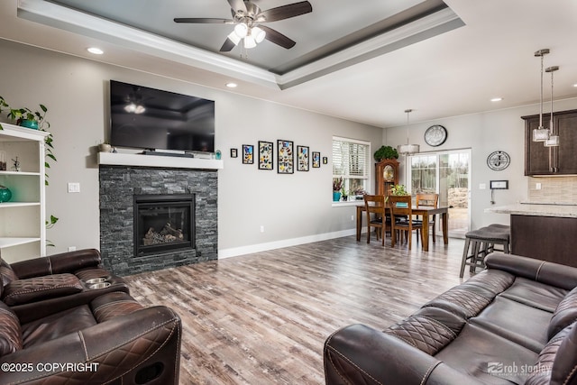 6552 N Michelle Rae St, Wasilla, AK 99654 - living room featuring crown molding, a ceiling fan, a tray ceiling, wood finished floors, and recessed lighting