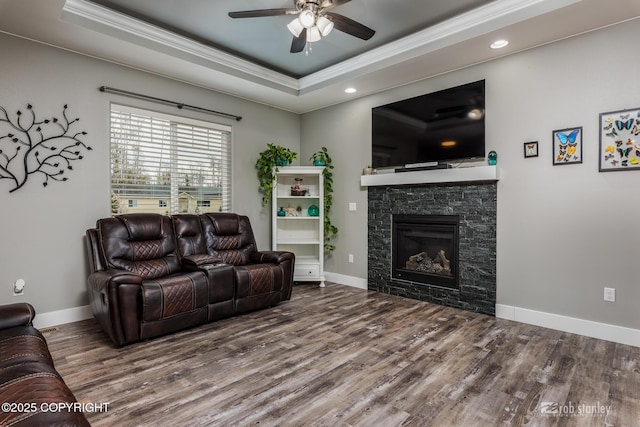 6552 N Michelle Rae St, Wasilla, AK 99654 - living room featuring crown molding, a tray ceiling, ceiling fan, wood finished floors, and a fireplace