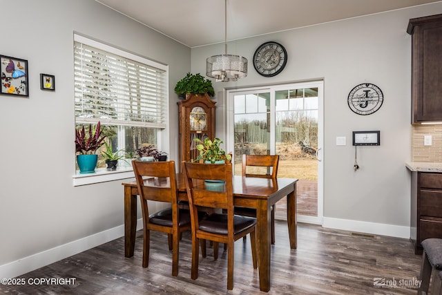 6552 N Michelle Rae St, Wasilla, AK 99654 - dining room featuring healthy amount of natural light, baseboards, a chandelier, and dark wood-style floors