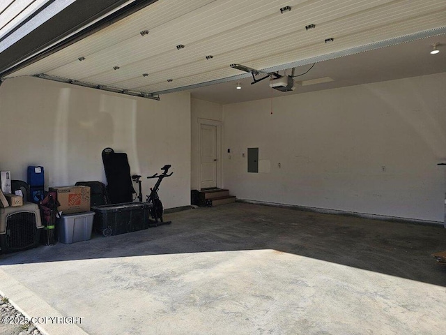 6552 N Michelle Rae St, Wasilla, AK 99654 - garage with electric panel, a garage door opener, and baseboards