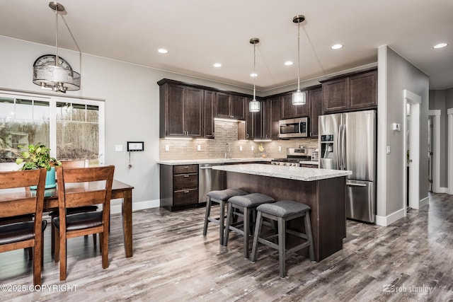 6552 N Michelle Rae St, Wasilla, AK 99654 - kitchen featuring stainless steel appliances, dark brown cabinetry, wood finished floors, and recessed lighting