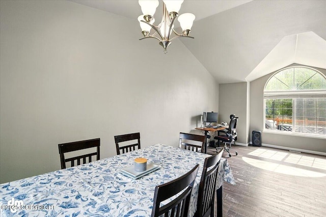1320 S Felton St, Palmer, AK 99645 - dining space featuring wood finished floors, a chandelier, vaulted ceiling, and baseboards