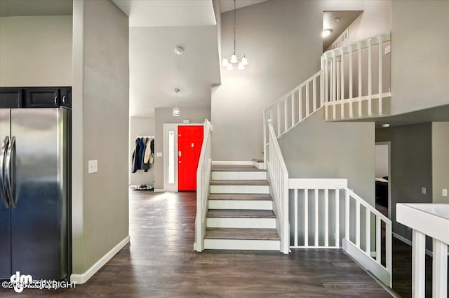 1320 S Felton St, Palmer, AK 99645 - staircase featuring a high ceiling, wood finished floors, a chandelier, and baseboards