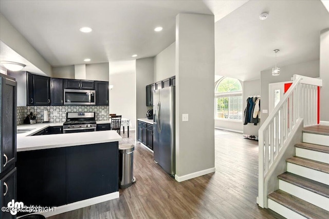 1320 S Felton St, Palmer, AK 99645 - kitchen with appliances with stainless steel finishes, light countertops, backsplash, wood finished floors, and baseboards