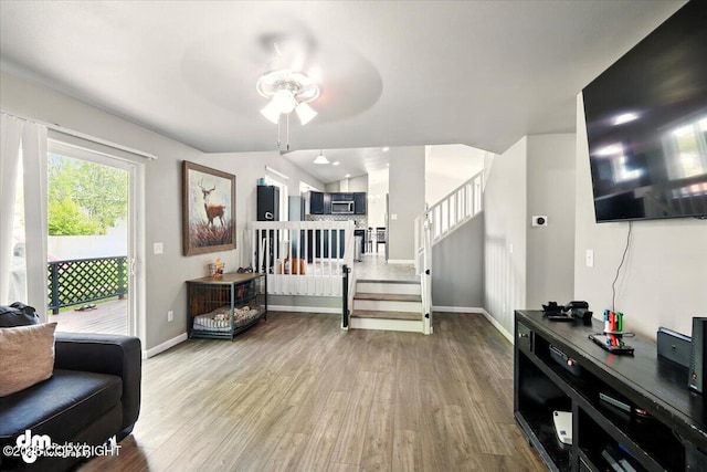 1320 S Felton St, Palmer, AK 99645 - living room with baseboards, wood finished floors, stairway, and a ceiling fan