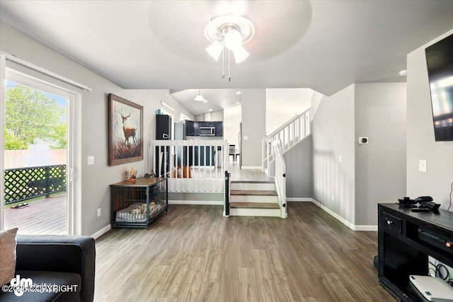 1320 S Felton St, Palmer, AK 99645 - foyer entrance featuring wood finished floors, a ceiling fan, stairs, and baseboards