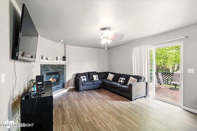 1320 S Felton St, Palmer, AK 99645 - living area with wood finished floors, ceiling fan, a fireplace, and baseboards