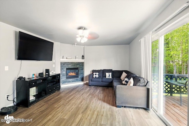 1320 S Felton St, Palmer, AK 99645 - living area with wood finished floors, ceiling fan, and a stone fireplace