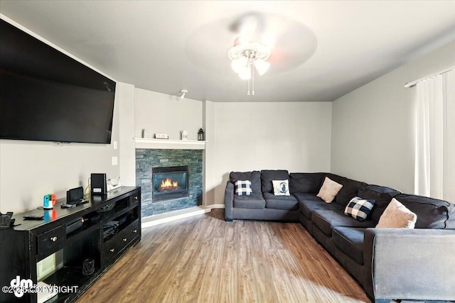 1320 S Felton St, Palmer, AK 99645 - living area featuring a ceiling fan, wood finished floors, and a fireplace