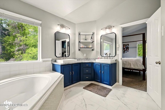 1320 S Felton St, Palmer, AK 99645 - ensuite bathroom featuring marble look tile flooring, double vanity, and a bath