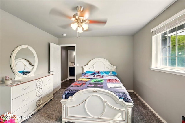 1320 S Felton St, Palmer, AK 99645 - bedroom with dark colored carpet, baseboards, and ceiling fan