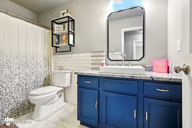 1320 S Felton St, Palmer, AK 99645 - full bathroom with tile walls, vanity, toilet, a wainscoted wall, and a shower with shower curtain