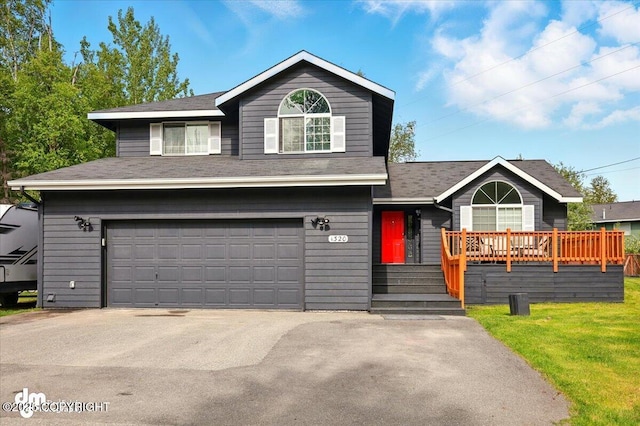 1320 S Felton St, Palmer, AK 99645 - view of front of property with an attached garage, concrete driveway, a front yard, and roof with shingles