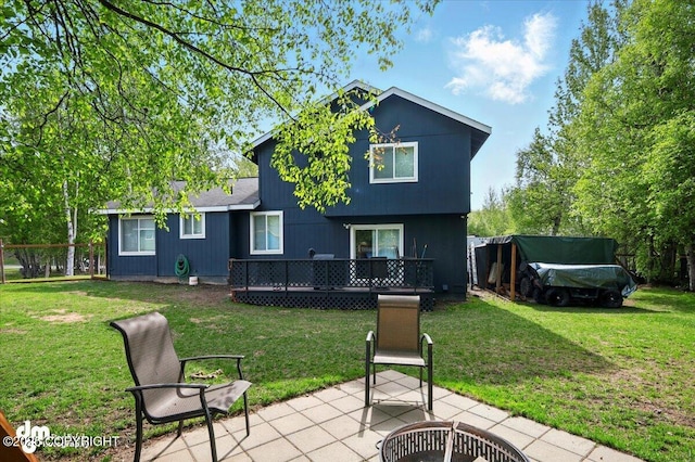 1320 S Felton St, Palmer, AK 99645 - rear view of property with a wooden deck, a patio, and a lawn
