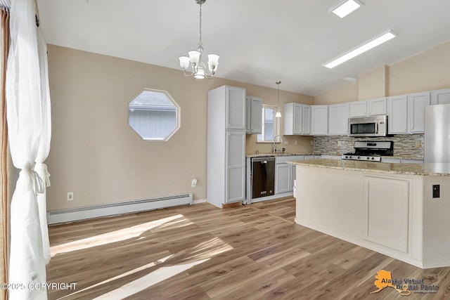 3233 Tayshee Cir, Anchorage, AK 99504 - kitchen featuring stainless steel appliances, a baseboard heating unit, lofted ceiling, a chandelier, and a sink