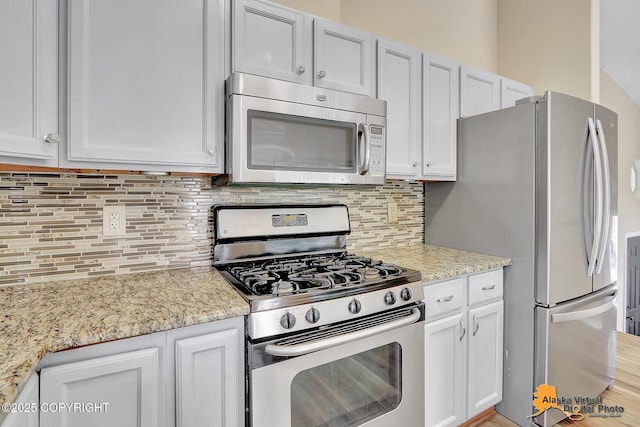 3233 Tayshee Cir, Anchorage, AK 99504 - kitchen featuring stainless steel appliances, tasteful backsplash, and white cabinets