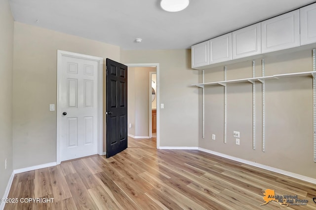 3233 Tayshee Cir, Anchorage, AK 99504 - unfurnished bedroom with baseboards and light wood-style flooring