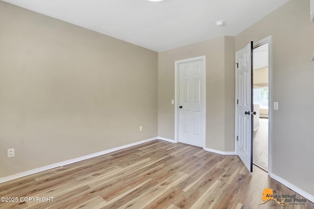 3233 Tayshee Cir, Anchorage, AK 99504 - empty room with light wood-style flooring, baseboards, and a smoke detector
