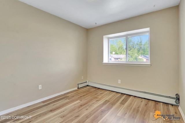 3233 Tayshee Cir, Anchorage, AK 99504 - unfurnished room with a baseboard radiator, light wood-style floors, and baseboards