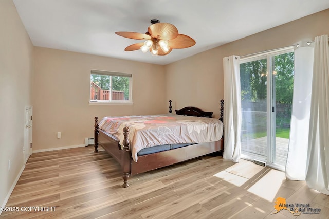 3233 Tayshee Cir, Anchorage, AK 99504 - bedroom featuring light wood-type flooring, access to exterior, a baseboard radiator, baseboards, and ceiling fan