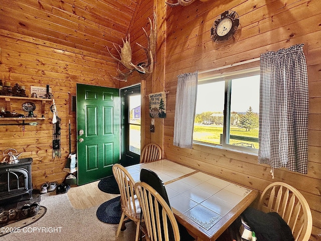 31795 Whiskey Gulch St, Anchor Point, AK 99556 - dining area with wood walls, a wood stove, and lofted ceiling