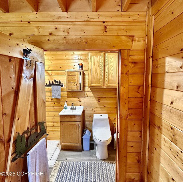 31795 Whiskey Gulch St, Anchor Point, AK 99556 - bathroom with toilet, vanity, and wooden walls