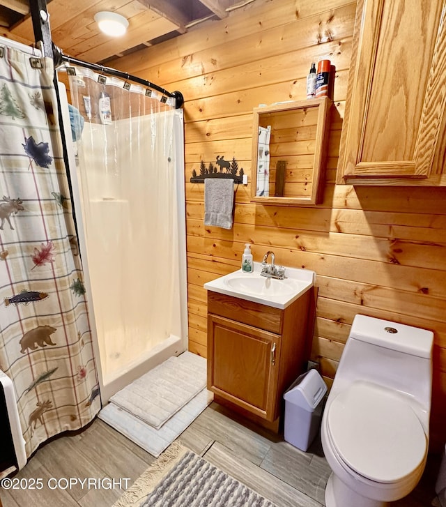 31795 Whiskey Gulch St, Anchor Point, AK 99556 - bathroom with a stall shower, vanity, wood walls, toilet, and wood finished floors