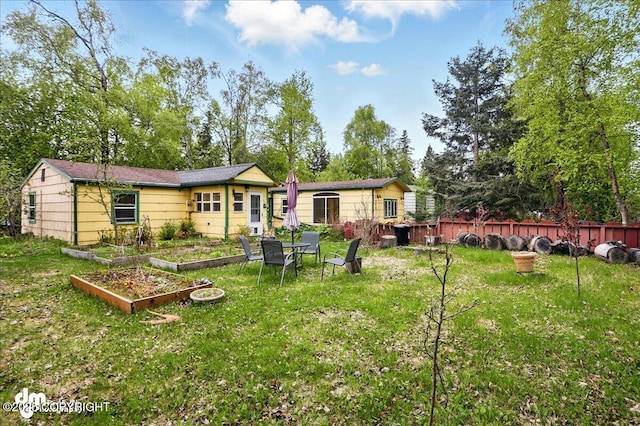 1948 Wildwood Ln, Anchorage, AK 99517 - rear view of property featuring a garden and view of scattered trees