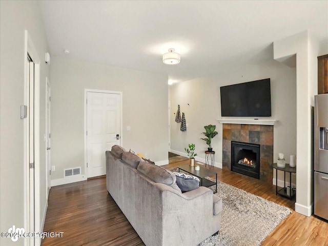 20182 Eagles Nest Ct # 5B, Eagle River, AK 99577 - living area with a fireplace, wood finished floors, and baseboards