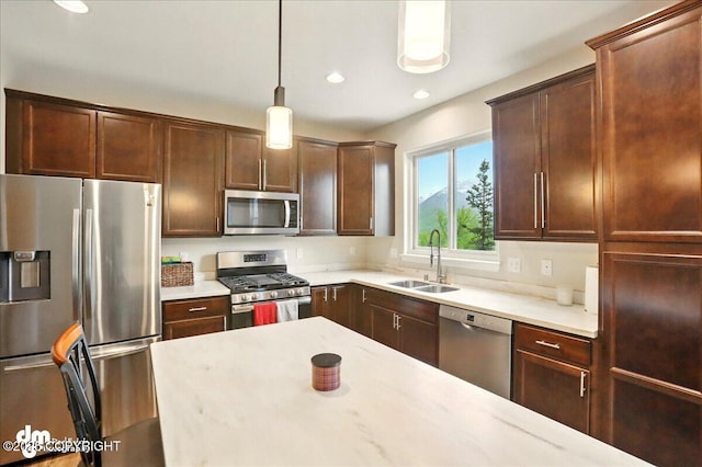 20182 Eagles Nest Ct # 5B, Eagle River, AK 99577 - kitchen with stainless steel appliances, a sink, pendant lighting, recessed lighting, and dark brown cabinetry