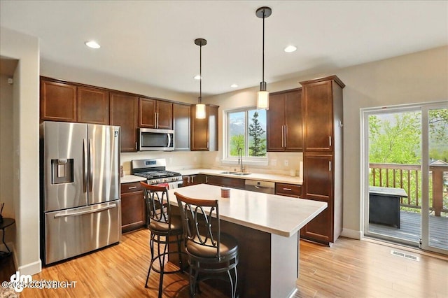 20182 Eagles Nest Ct # 5B, Eagle River, AK 99577 - kitchen with appliances with stainless steel finishes, healthy amount of natural light, light countertops, light wood-type flooring, and recessed lighting